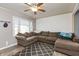 Comfortable living room featuring a large sectional couch, a ceiling fan, and a geometric patterned rug at 2704 13Th St, Columbus, IN 47201