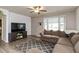 Inviting living room with comfortable sectional sofa, modern ceiling fan, and stylish rug at 2704 13Th St, Columbus, IN 47201