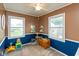 Playroom featuring two-tone walls, a ceiling fan, and several windows letting in natural light at 2704 13Th St, Columbus, IN 47201