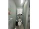 Cozy bathroom features a toilet, a built-in cabinet, and nautical decor for a serene, beach-inspired atmosphere at 2916 Wind Chime Cir, Greenwood, IN 46143