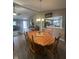 Open-concept dining area with a large wooden table, views of the living room, and kitchen at 2916 Wind Chime Cir, Greenwood, IN 46143