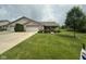 Charming single-story home boasting a well-manicured lawn, mature tree, and a two-car garage at 2916 Wind Chime Cir, Greenwood, IN 46143