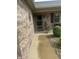 Close-up of a brick home's entry, showing a covered porch with planters and decorative details at 2916 Wind Chime Cir, Greenwood, IN 46143
