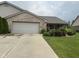 Charming brick home with an attached garage and driveway, complemented by neat landscaping at 2916 Wind Chime Cir, Greenwood, IN 46143