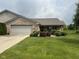 Well-maintained brick home featuring an attached garage and a beautifully landscaped front yard at 2916 Wind Chime Cir, Greenwood, IN 46143