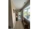 Neutral-toned hallway with a bay window, bench seating, and a view into a screened-in porch at 2916 Wind Chime Cir, Greenwood, IN 46143