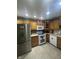 Kitchen with wooden cabinetry, stainless steel refrigerator, and white appliances at 2916 Wind Chime Cir, Greenwood, IN 46143