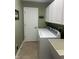 Functional laundry room with white cabinets, appliances, and a utility sink at 2916 Wind Chime Cir, Greenwood, IN 46143