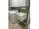 Functional laundry room features a utility sink, washer and dryer, and ample storage with overhead cabinets at 2916 Wind Chime Cir, Greenwood, IN 46143