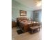 Cozy main bedroom featuring a wooden bed frame, quilt, and an ensuite bathroom at 2916 Wind Chime Cir, Greenwood, IN 46143