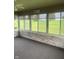 Bright sunroom with brick wall, window views and neutral carpeting at 2916 Wind Chime Cir, Greenwood, IN 46143