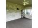 Well-lit sunroom with exposed brick, windows, and dark carpeting at 2916 Wind Chime Cir, Greenwood, IN 46143
