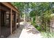Backyard featuring a concrete patio, wooden fence, and mature trees at 2947 Talping Row, Indianapolis, IN 46268