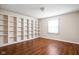 Bedroom with a wall of built-in shelves and wood floors at 2947 Talping Row, Indianapolis, IN 46268