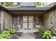Inviting front entrance with stone accents, decorative plants and address number above the door at 2947 Talping Row, Indianapolis, IN 46268