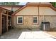 Back exterior of home with stone accents and a screened-in porch at 2947 Talping Row, Indianapolis, IN 46268