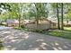Charming single-Gathering home featuring a stone facade, complemented by mature trees and a rustic wooden fence at 2947 Talping Row, Indianapolis, IN 46268
