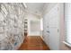 Foyer featuring hardwood floors, a stone wall and views into the living areas at 2947 Talping Row, Indianapolis, IN 46268