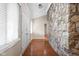Entryway with wood floors, stone accent wall, closet doors and bright natural light at 2947 Talping Row, Indianapolis, IN 46268