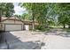 View of garage with driveway and mature trees providing shade; close to the street at 2947 Talping Row, Indianapolis, IN 46268