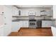 Updated kitchen featuring stainless steel appliances, granite countertops, and wooden floors at 2947 Talping Row, Indianapolis, IN 46268