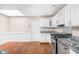Well-lit kitchen featuring stainless steel appliances, white cabinets, and a skylight for natural light at 2947 Talping Row, Indianapolis, IN 46268