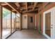 Covered and screened patio with wooden accents and neutral-toned concrete floor at 2947 Talping Row, Indianapolis, IN 46268