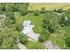 Expansive aerial view of the property, showcasing the home, outbuilding, and surrounding greenery and farmland at 312 W Clark Ln, Fairland, IN 46126