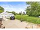 Spacious backyard featuring an open lawn, outdoor patio, and additional structure at 312 W Clark Ln, Fairland, IN 46126
