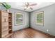 Bedroom with hardwood floors, two windows, and a bookshelf at 312 W Clark Ln, Fairland, IN 46126