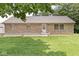 Charming brick home with a well-manicured lawn and welcoming front porch at 312 W Clark Ln, Fairland, IN 46126