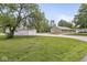 Well-maintained front yard with a brick home, gravel driveway, and a spacious outbuilding, perfect for storage at 312 W Clark Ln, Fairland, IN 46126