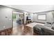 Inviting living room with hardwood floors, a comfortable gray sofa, and a view into the adjacent kitchen at 312 W Clark Ln, Fairland, IN 46126