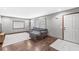 Cozy living room features hardwood floors, a comfortable sectional sofa, and natural light from nearby windows at 312 W Clark Ln, Fairland, IN 46126