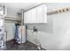 Functional utility room with modern water heater, storage cabinets, and durable flooring at 312 W Clark Ln, Fairland, IN 46126