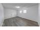 Inviting bedroom features modern flooring, an exit door, and well-lit windows creating a cozy atmosphere at 3220 Newton Ave, Indianapolis, IN 46201