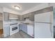 Modern kitchen with gray cabinets, stainless steel appliances, and neutral countertops at 3220 Newton Ave, Indianapolis, IN 46201