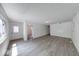 Open living room with light gray flooring, offering a versatile space for entertaining at 3220 Newton Ave, Indianapolis, IN 46201