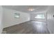 Bright living room with large windows and neutral gray flooring, perfect for modern living at 3220 Newton Ave, Indianapolis, IN 46201