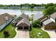 Aerial view of brick home with an attached two car garage and waterfront views at 3404 Maritime Dr, Indianapolis, IN 46214