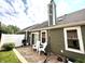 Exterior view of the home with a stamped concrete patio, outdoor chairs, grill, and well-maintained siding at 3404 Maritime Dr, Indianapolis, IN 46214