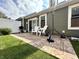 Exterior view of the home with a stamped concrete patio, outdoor chairs, grill, and well-maintained siding at 3404 Maritime Dr, Indianapolis, IN 46214