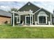 Relaxing backyard patio featuring a pergola, outdoor seating, and lush green lawn at 3404 Maritime Dr, Indianapolis, IN 46214