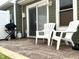 Backyard with stamped concrete patio featuring a grill, white chairs, and easy access to the home at 3404 Maritime Dr, Indianapolis, IN 46214