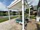Backyard stamped concrete patio featuring a pergola with outdoor seating and scenic lake views at 3404 Maritime Dr, Indianapolis, IN 46214