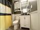 Well-lit bathroom with modern fixtures, vanity, and bathtub with stylish shower curtain at 3404 Maritime Dr, Indianapolis, IN 46214
