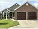 Charming brick facade with a two-car garage, well-manicured lawn, and inviting curb appeal at 3404 Maritime Dr, Indianapolis, IN 46214