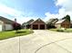 Lovely brick and vinyl home with a two-car garage, surrounded by mature trees and green lawns at 3404 Maritime Dr, Indianapolis, IN 46214