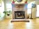 Brick fireplace in a naturally lit living area with potted plants at 3404 Maritime Dr, Indianapolis, IN 46214