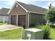 Double garage door exterior with brick and vinyl siding, surrounded by a well-maintained lawn at 3404 Maritime Dr, Indianapolis, IN 46214